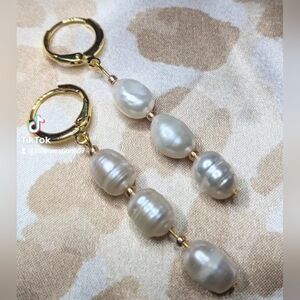 Gold plated drop earrings with three dangling potato pearls.